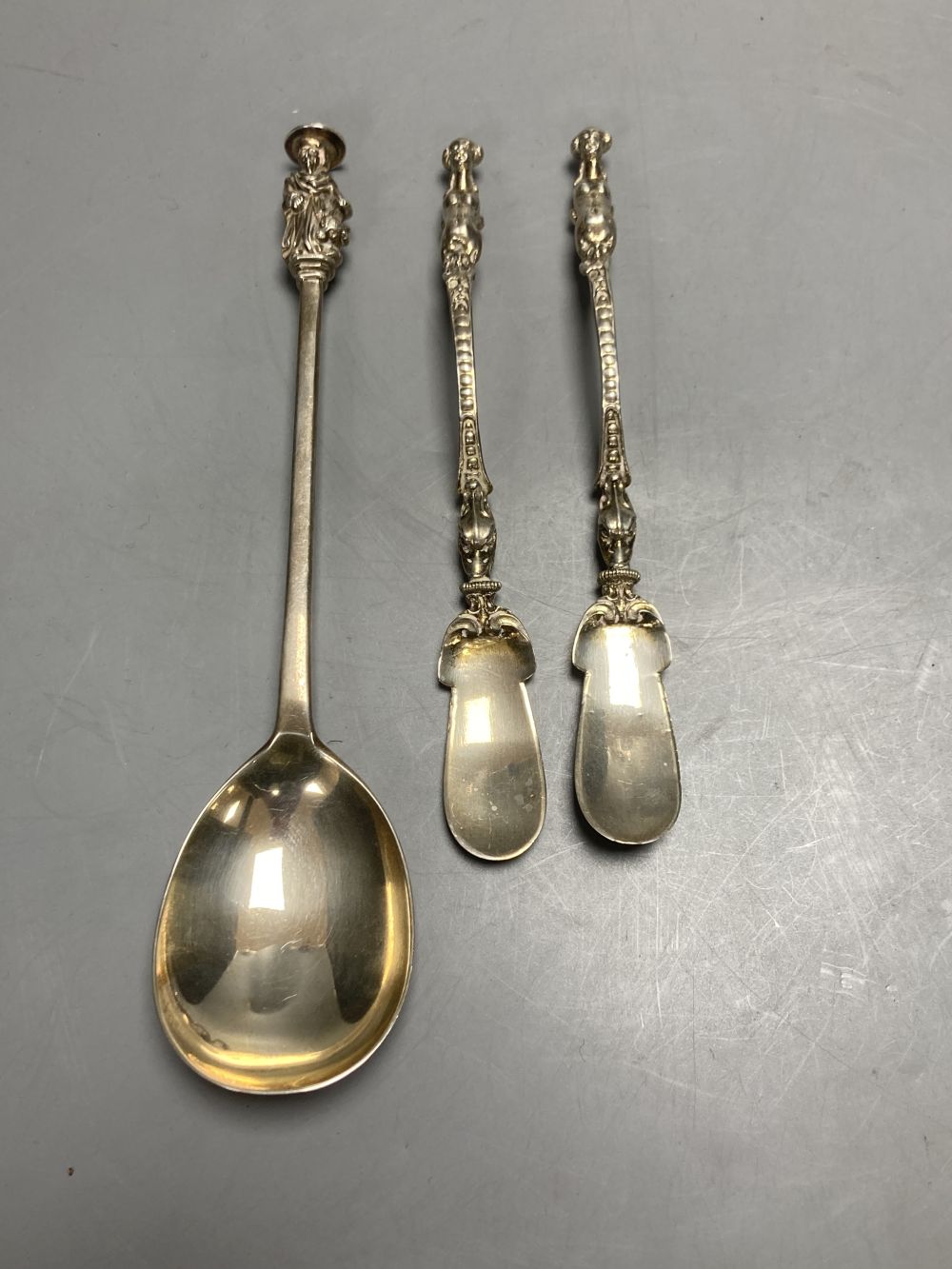 An Edwardian silver seal top spoon, London, 1905, 19.9cm and a pair of novelty plated spoons with figural handles.